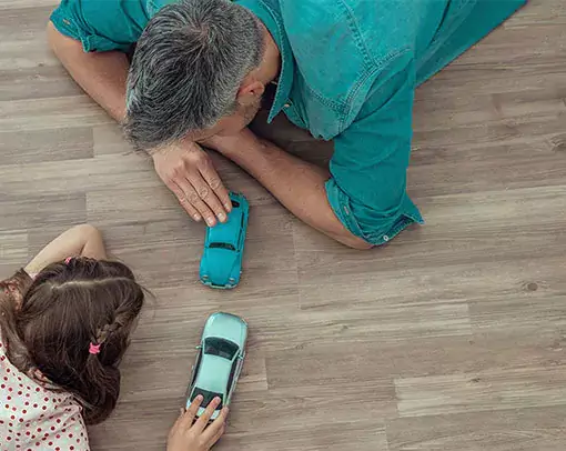 after-vinyl-installation Dad and daughter playing toys | Legend Flooring
